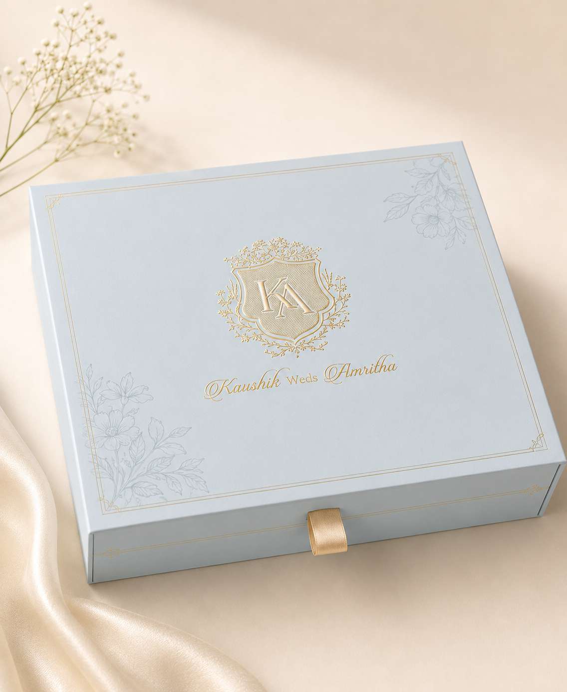 Pale blue rigid drawer box with gold monogram and ribbon pull